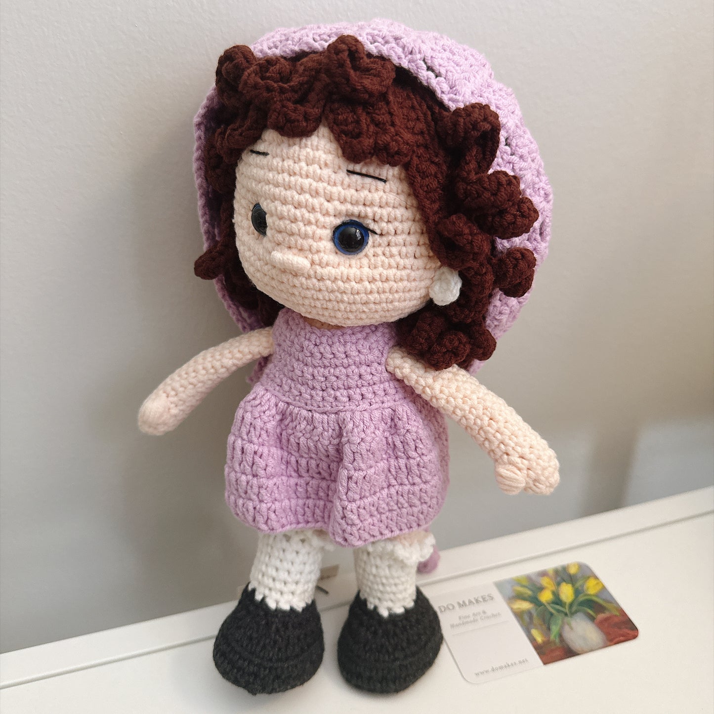 Brown hair doll in purple dress & hat