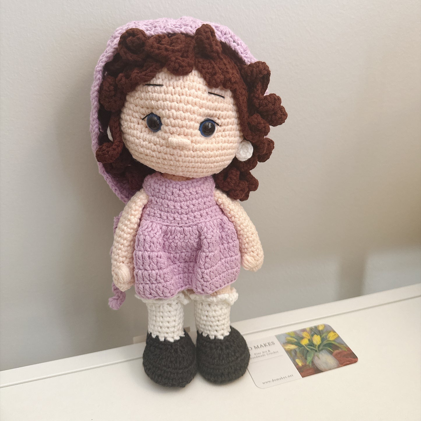 Brown hair doll in purple dress & hat