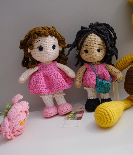 Black hair doll in pink dress with turquoise purse
