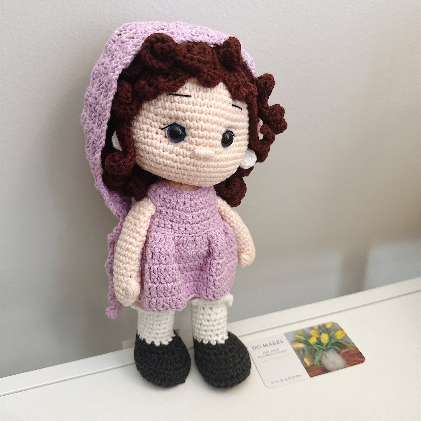 Brown hair doll in purple dress & hat