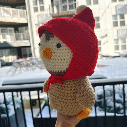 Penguin wearing a red wool hat