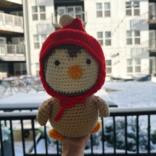 Penguin wearing a red wool hat