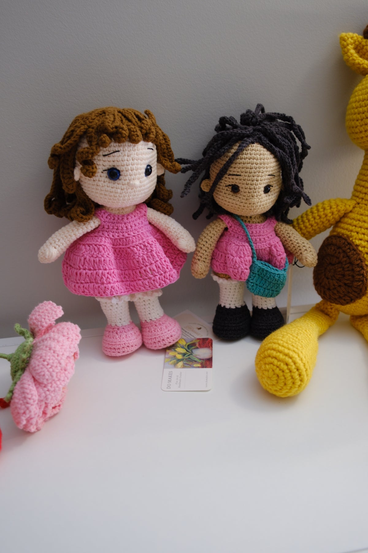 Black hair doll in pink dress with turquoise purse