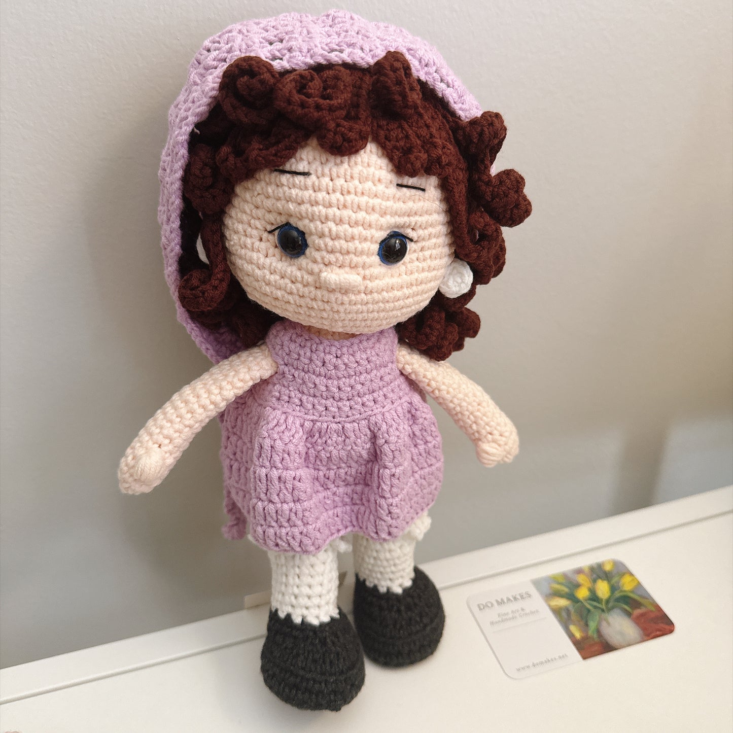 Brown hair doll in purple dress & hat